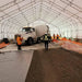 Interior worksite showing concrete truck and workers, Snow Series™ 40' x 60' Dual Truss Storage Shelter