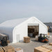 Snow Series 40' x 80' Dual Truss Storage Shelter at warehouse yard with forklifts.
