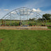 Customer photo: galvanized steel tunnel greenhouse frame with door, front view, before the poly cover is installed