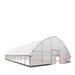 Angled view showing open doorway and side tension straps on Commercial Tunnel Greenhouse.