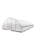 Low-angle view highlighting front door and cover seams on Commercial Tunnel Greenhouse.