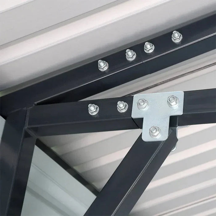 Close-up of gusset plate and bolts on roof frame, metal garage shed.