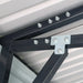 Close-up of gusset plate and bolts on roof frame, metal garage shed.