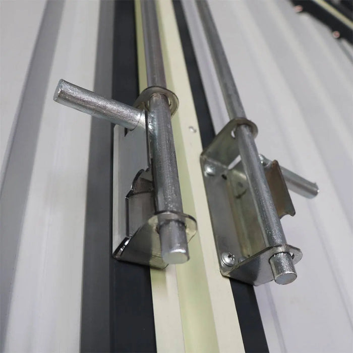 Detail close-up of steel sliding door bolts on metal garage shed.