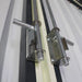 Detail close-up of steel sliding door bolts on metal garage shed.