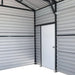 Interior corner showing side entry door and metal wall panels, metal garage shed.
