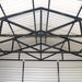 Interior ceiling showing truss network and corrugated panels in metal garage shed