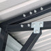 Bolted truss connector and roof panels close-up inside metal garage shed