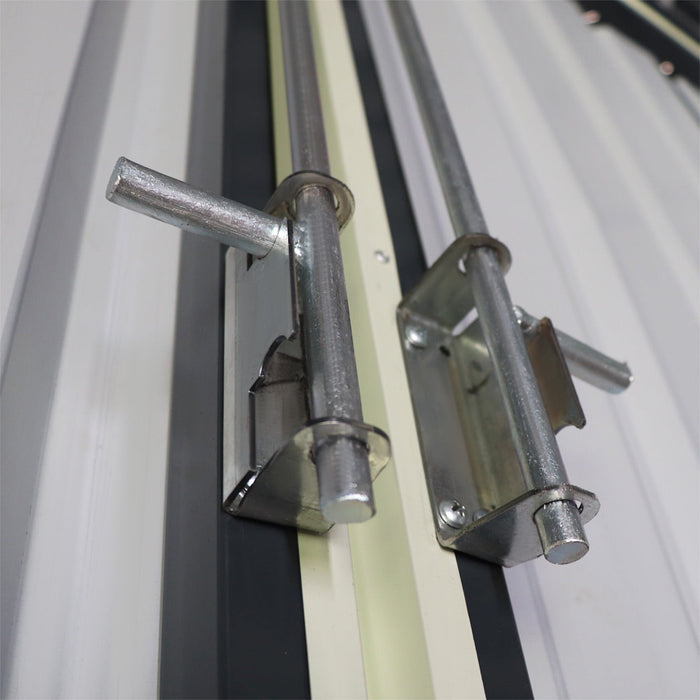 Detail of sliding latch pins and receivers on metal garage shed doors
