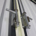 Detail of sliding latch pins and receivers on metal garage shed doors